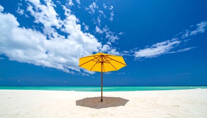 A vibrant yellow beach umbrella casts a welcoming shadow on a pristine white sand beach, bathed in the warm sunlight of a brilliant summer day.