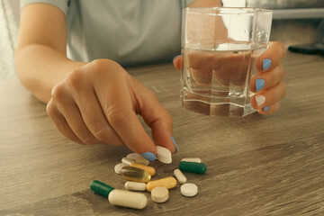 Woman taking vitamins and supplements. Medical concept. Woman taking vitamins or pills for...