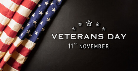 Happy Veterans Day concept. American flags against a dark stone  background. November 11.