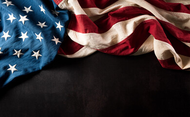 Happy Veterans Day concept. American flags against a dark stone  background. November 11.
