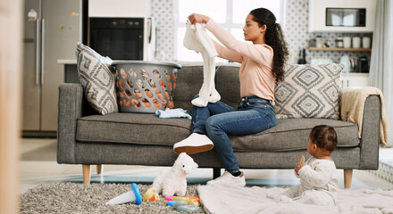 Mother, folding baby clothes and couch in home, care and domestic chores in lounge with basket....