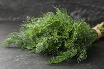 Bunch of fresh dill on black table, closeup