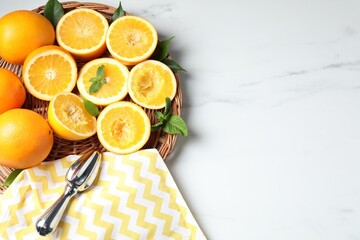 Squeezer, oranges and mint on white table, flat lay with space for text. Making fresh juice