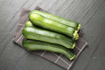 Fresh ripe zucchinis on black table, top view