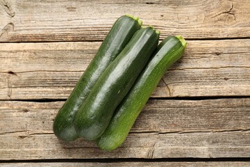 Fresh ripe zucchinis on wooden table, flat lay