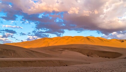 Fototapeta premium Golden Sand Dunes at Sunset Under a Cloudy Sky