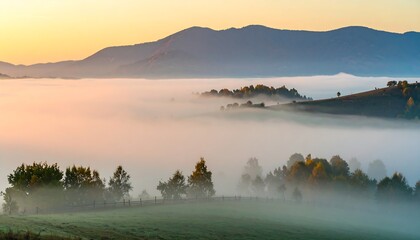 A tranquil landscape bathed in the soft hues of sunrise, with layers of mist enveloping rolling hills and trees.