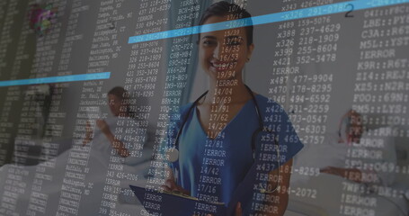 Standing female medical team with stethoscopes reviewing tablet in hospital hall, with code overlay