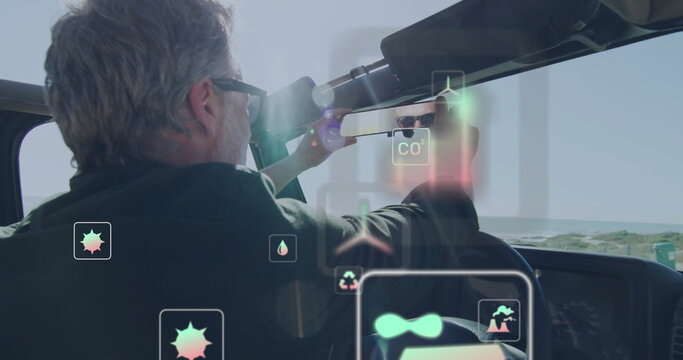 Adjusting man scanning coastline using monocular in convertible by dunes, AR icons, copy space