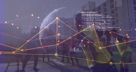 Youth coach in tracksuit leading players training on turf at dusk, with cones and data graphics