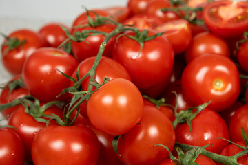 Lots of ripe fresh cocktail tomatoes close-up.