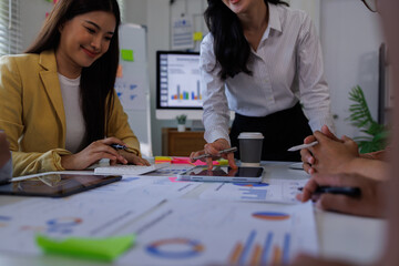 Fototapeta premium Corporate accountant Asian team use accounting software on laptop to calculate and maximize tax refund and improve financial performance base on financial data, business accounting . 