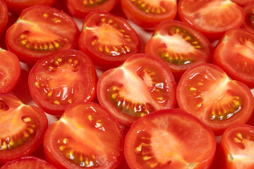 Close-Up of Fresh Cut Small Tomatoes. Vibrant Red Culinary Background.