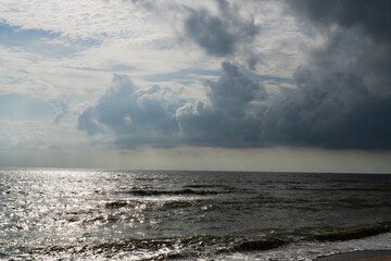 Powerful waves crash on the coast under a dramatic sky and Storm clouds gathering over the ocean waves near the coast in morning