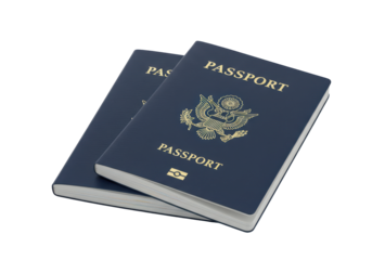 Isolated American passports in navy-blue cover stacked one on another ready for travel
