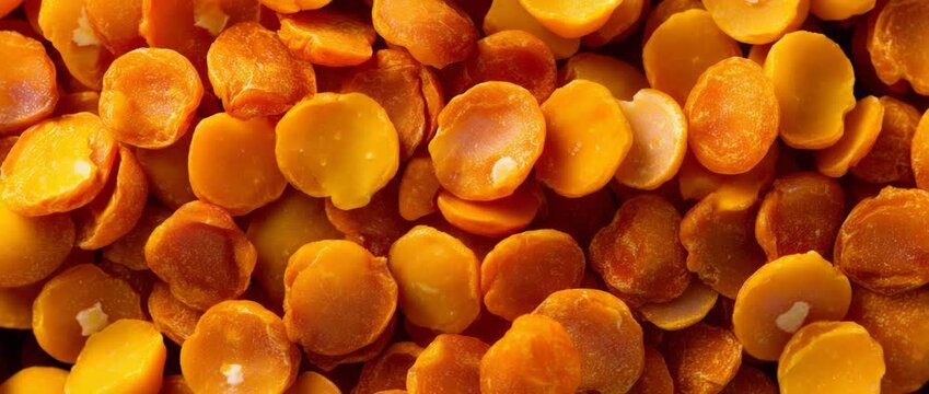 Macro close-up capturing the vibrant texture and golden hue of split yellow peas