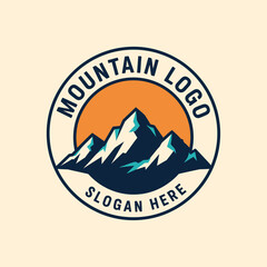 Mountain logo design featuring snowy peaks against an orange sun, encircled by a dark blue border with text.