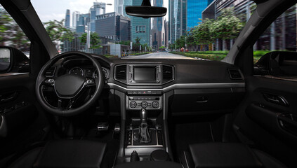 A black car with a black steering wheel and a black dashboard