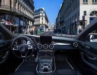 A car with a black steering wheel and a black dashboard