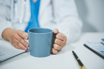 Female scientist holding coffee mug in laboratory