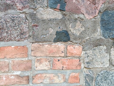 Colorful brick and stone masonry with contrasting shapes and pastel colors