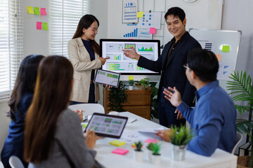 Asian team lead young group of multiethnic businesspeople in team meeting, using computer for ESG topic presentation on monitor. Sustainable business practice, people work esg concept
