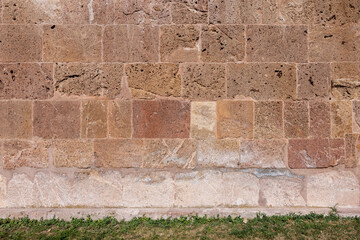 Old stone wall showing its weathered texture and natural earthy tones