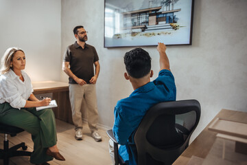 Architects discussing house designs in a modern professional office