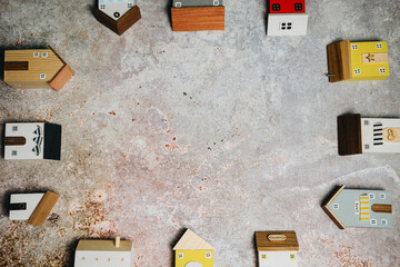 Colorful Wooden Toy Houses on Textured Surface for Creative Play and Learning Activities
