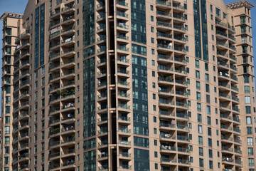 Fototapeta premium modern apartment building with balconies and laundry drying in Shanghai, China