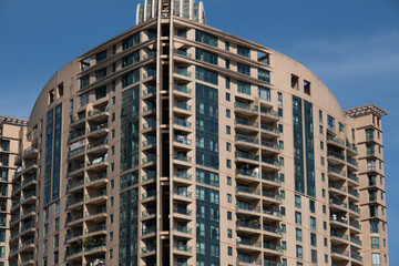 Fototapeta premium modern apartment building with balconies and laundry drying in Shanghai, China