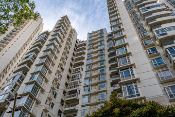 Fototapeta premium modern apartment building with balconies and laundry drying in Shanghai, China