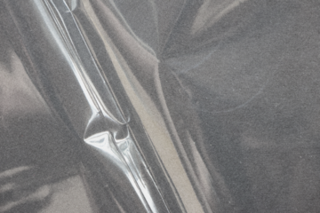 Transparent plastic wrap texture overlay effect. polyethylene wrapping stretch film background. Shrink crumpled plastic sleeve surface.