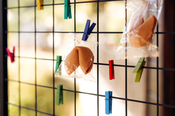 Fortune cookies hanging on clothespins as party entertainment decoration.