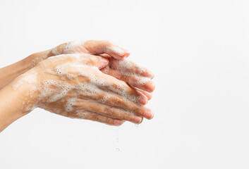 Close-up of hands washing with soap and water, covered in foam and bubbles on white background. Personal hygiene, health care, prevention of infection and virus protection.