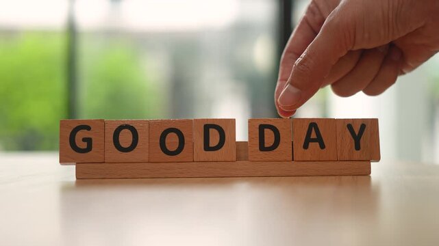 People hand is alignment English alphabet as "Good day" word. Good abstract attitude concept scene.