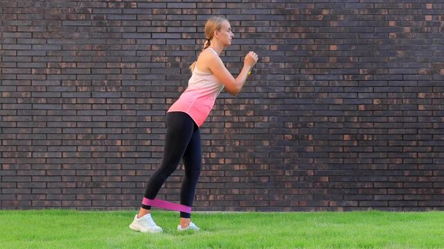 Woman Exercising with Resistance Band Outdoors