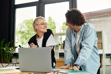 Young professionals collaborate in a modern office space while sharing ideas and smiles