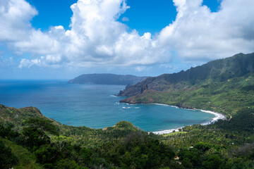 Coastal cliffs and turquoise bay near Puamau, Hiva Oa, Marquesas Islands, French Polynesia