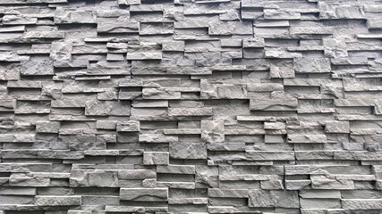 Textured Gray Stone Wall with Unique Layered Design for Background Use