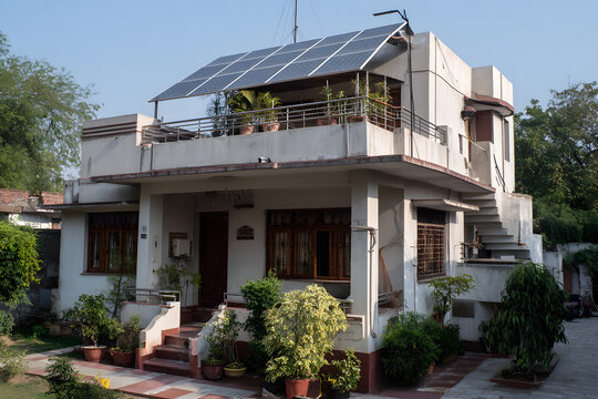 Contemporary two-story home in Karachi, Pakistan, with rooftop solar array.