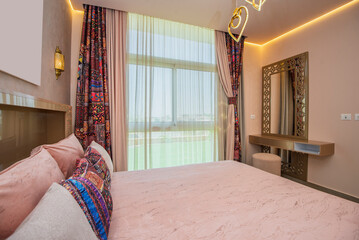 Interior design decor furnishing of luxury show home bedroom showing furniture and double bed with...