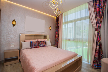 Interior design decor furnishing of luxury show home bedroom showing furniture and double bed with...