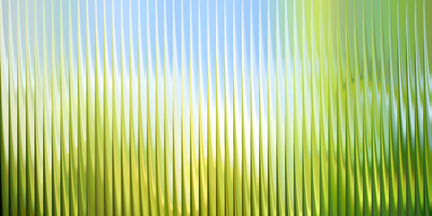 A fresh abstract background with a green and blue nature gradient seen through ribbed glass. A bright, serene texture for wellness branding, eco-friendly concepts, or spring promotions.