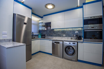 Interior design decor showing modern kitchen and appliances in luxury apartment showroom with extractor fan