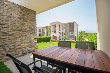 Garden patio terrace of a luxury apartment home in tropical resort with furniture and garden