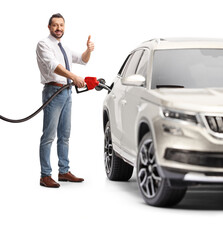 Man refueling a car with petrol and gestureing thumbs up