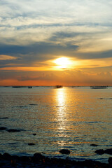 sunset in the sea. Beautiful colorful sky and cloud in twilight time background. Orange fluffy clouds and sun sunlight reflection in the blue sky.