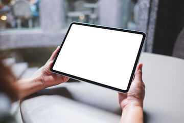 Mockup image of a woman holding digital tablet with blank white desktop screen