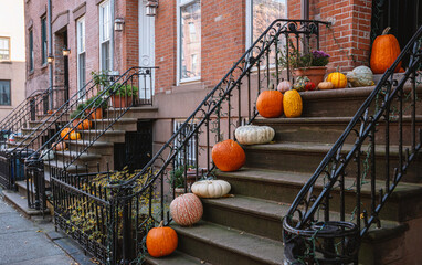 Colorful Pumpkins and Halloween decorations on the Stairs of an Old Brownstone Home